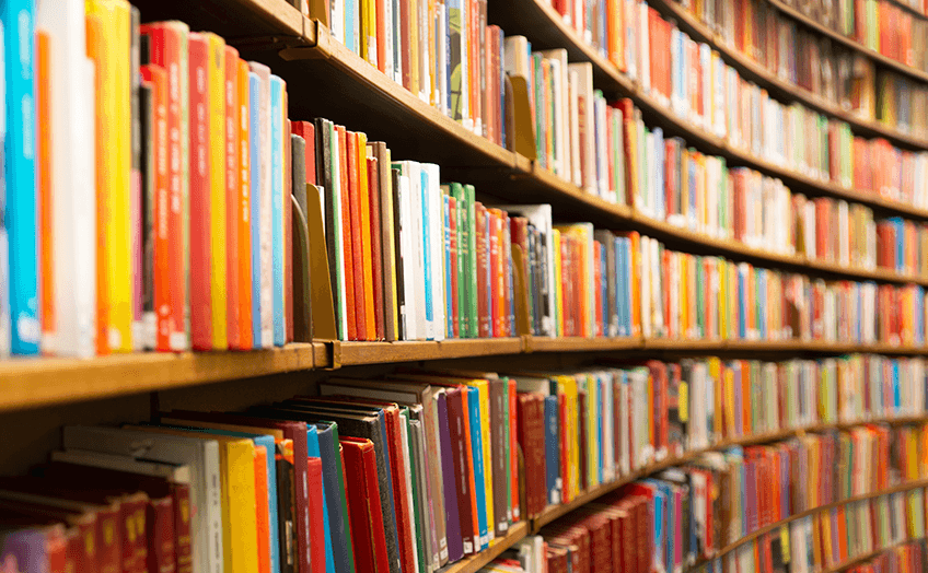 Library full of colorful books in different shelves.